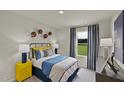 Stylish bedroom with a bright window view, sport-themed decorations, and sleek bedside lamps at 2258 Cherry Creek Rd, Haw River, NC 27258