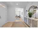 Inviting foyer with wood-look floors and view to a home office space at 248 Speight Branch Rd, Cary, NC 27518