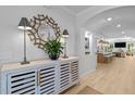 The foyer's decorative mirror and table with lamps, with an archway leading to the kitchen at 248 Speight Branch Rd, Cary, NC 27518