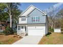Charming two-story home featuring a blend of light siding and blue shingle accents at 3001 Sadie Hopkins St, Raleigh, NC 27616