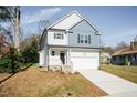 Charming two-story home features a blend of light siding and blue shingle accents at 3001 Sadie Hopkins St, Raleigh, NC 27616