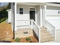 Inviting front porch with brick stairs and white railings provides a welcoming entrance at 3001 Sadie Hopkins St, Raleigh, NC 27616