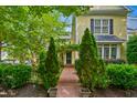 Inviting front entrance with a brick pathway leading to the door, framed by manicured greenery at 4001 Falls River Ave, Raleigh, NC 27614