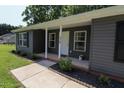 Inviting front porch featuring classic columns and fresh landscaping around the home at 420 E Grandview Ave, Liberty, NC 27298