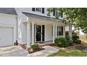 A close-up of the front entrance shows the pillars and plants that surround the porch at 4213 Stoneford Trace Dr, Raleigh, NC 27616