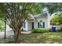 Exterior view of a home with white siding, blue shutters, and well-maintained landscaping at 5006 Silhouette Dr, Durham, NC 27713