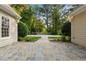 Stylish backyard with a stone patio leading to the pool, perfect for outdoor entertaining at 5344 Mill Dam Rd, Wake Forest, NC 27587