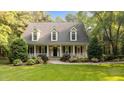 Charming home featuring a welcoming front porch and a beautifully landscaped front yard at 5344 Mill Dam Rd, Wake Forest, NC 27587