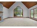 Spacious living room with large windows, a stone fireplace, vaulted ceilings, and ample natural light at 5344 Mill Dam Rd, Wake Forest, NC 27587