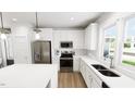 Contemporary kitchen featuring stainless steel appliances, white cabinets and island with hardwood floors at 537 Folk Song Way, Wendell, NC 27591