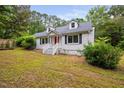 Attractive house featuring a bright red door, white trim and tidy front yard at 5601 Buffaloe Rd, Raleigh, NC 27616