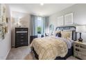Cozy bedroom with a plush bed, side tables, dresser, decor, and a window offering natural light at 685 White Birch Ln, Angier, NC 27501