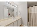 Clean bathroom with a spacious vanity, white sink, and combination shower and tub at 72 Justin Ct, Durham, NC 27705