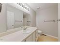 Clean, well-lit bathroom with a spacious vanity, white sink, and neutral-colored walls at 72 Justin Ct, Durham, NC 27705