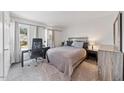 Bright bedroom featuring soft carpet, a large window with light curtains, and calming neutral paint at 72 Justin Ct, Durham, NC 27705