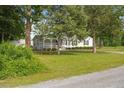 Charming single-story home with a cozy front porch and lush green lawn at 784 Crawford Rd, Coats, NC 27521