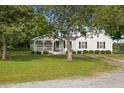 Charming single-story home with a cozy front porch, swing and lush green lawn at 784 Crawford Rd, Coats, NC 27521