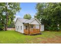 Charming single-story home with natural wood porch, perfect for enjoying the serene backyard and outdoor living at 807 S Mebane St., Burlington, NC 27215