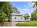 Well-maintained single-story home with gray siding, black roof, driveway and green lawn, creating a great first impression at 807 S Mebane St., Burlington, NC 27215