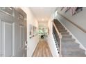 Welcoming entryway with wood floors leading to a staircase and view of the living spaces at 812 Ottawa Dr, Garner, NC 27529