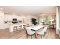 Open-concept living and dining area with ample seating, island, and natural light at 812 Ottawa Dr, Garner, NC 27529