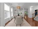Bright dining room featuring modern chandelier, hardwood floors, and stylish decor at 904 Pirouette Ct, Raleigh, NC 27606