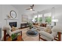 Cozy living room featuring a fireplace, large windows, and comfortable seating at 904 Pirouette Ct, Raleigh, NC 27606