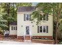 Charming two-story yellow home with a landscaped front yard and grey shutters at 1 Old Towne Pl, Durham, NC 27713