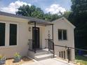 Charming home entrance featuring a covered porch, clean lines, and well-maintained landscaping at 100 Eastwood Lake Rd Rd, Chapel Hill, NC 27514