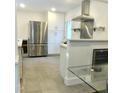 Clean, updated kitchen with stainless steel appliances, white cabinetry, and wine cooler at 100 Eastwood Lake Rd Rd, Chapel Hill, NC 27514