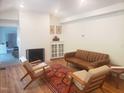 Bright living room with fireplace, hardwood floors, stylish furniture, and decorative accents at 100 Eastwood Lake Rd Rd, Chapel Hill, NC 27514