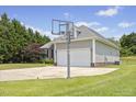 View of a spacious driveway and backyard with basketball hoop at 101 Hazel Ln Ln, Broadway, NC 27505