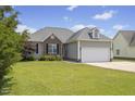 Charming single Gathering home featuring a two-car garage and landscaped front yard at 101 Hazel Ln Ln, Broadway, NC 27505