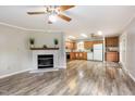 Bright living room featuring wood flooring, a fireplace, and a combined kitchen dining area at 1033 Sagamore Dr, Louisburg, NC 27549