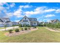 Scenic home with landscaped yard, stone-lined garden, and lush green lawn at 121 Nate Ct, Wake Forest, NC 27587