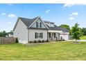 Stylish two-story home featuring gray siding, a well-kept lawn, and a convenient two car garage at 137 Clydes Point Way, Wendell, NC 27591