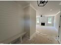 Inviting entryway featuring a built-in bench and open view into the living room with a fireplace at 145 Tee Dr, Selma, NC 27576