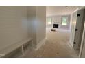 Bright entryway with a built-in bench, leading to a living area with a fireplace at 145 Tee Dr, Selma, NC 27576