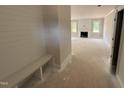 Entryway showcasing a shiplap accent wall with a built-in bench and a view into the living space at 145 Tee Dr, Selma, NC 27576