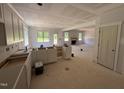 Kitchen under construction, featuring ample cabinetry and large windows overlooking the yard at 145 Tee Dr, Selma, NC 27576