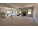 Spacious living room under construction, featuring a fireplace and ample natural light at 145 Tee Dr, Selma, NC 27576