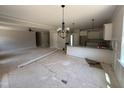 Spacious living area connecting to the kitchen with modern lighting fixtures and ample space at 145 Tee Dr, Selma, NC 27576