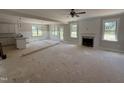 Open living area with fireplace, abundant natural light, and view into the kitchen at 145 Tee Dr, Selma, NC 27576