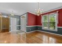 Formal dining area featuring hardwood floors, chair rail, chandelier, and large windows at 1614 E Hardscrabble Dr, Hillsborough, NC 27278