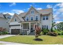 Inviting two-story home with a well-kept lawn, tasteful landscaping, and a welcoming front porch at 1716 Aberdour Dr, Apex, NC 27502