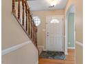Welcoming foyer with hardwood floors, a staircase, and natural light at 1966 Grassy Banks Dr, Raleigh, NC 27610