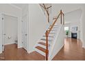 Bright entryway with staircase and hardwood floors leading to a spacious living area at 2036 October Dr, Durham, NC 27703