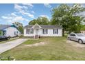 A quaint single-Gathering home with white siding and a green lawn, evoking a sense of suburban tranquility at 205 Person St, Oxford, NC 27565