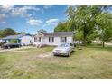 Exterior view with a well-manicured lawn and a classic car, showcasing the property's curb appeal at 205 Person St, Oxford, NC 27565