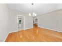 Hardwood floors and a modern light fixture create an elegant dining space at 2409 Horizon Hike Ct, Raleigh, NC 27603